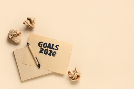 Card with text GOALS 2026, pen and crumpled paper on beige backgroundの写真素材