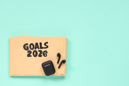 Notebook with 2026 goals and earphones on green backgroundの写真素材