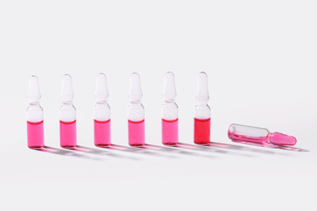 Glass ampoules on light background