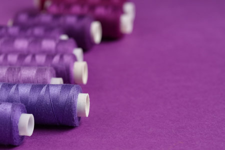 Spools of thread on purple background, closeupの写真素材