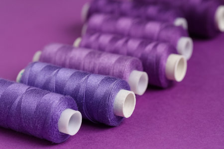 Spools of thread on purple background, closeupの写真素材