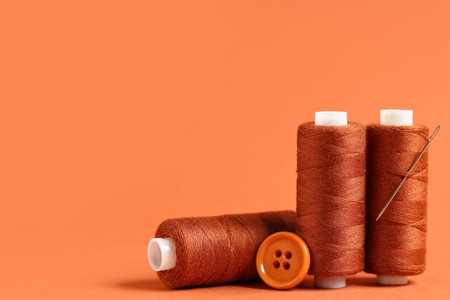Spools of thread with needle and buttonの写真素材