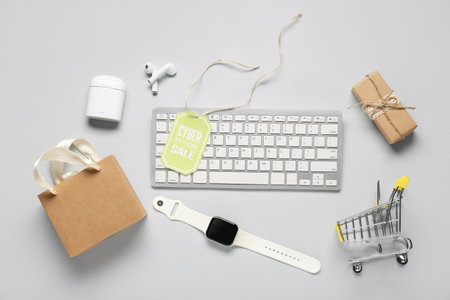 Gadgets with shopping bag, card and gift on light background. Cyber Mondayの写真素材