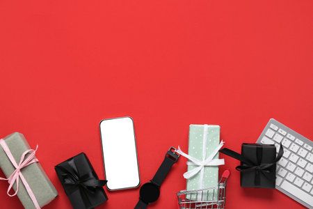 Gifts with gadgets on red background. Cyber Mondayの写真素材