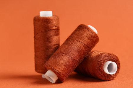 Spools of thread on brown background