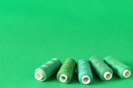 Spools of thread on green backgroundの写真素材