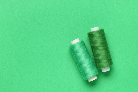 Spools of thread on green background