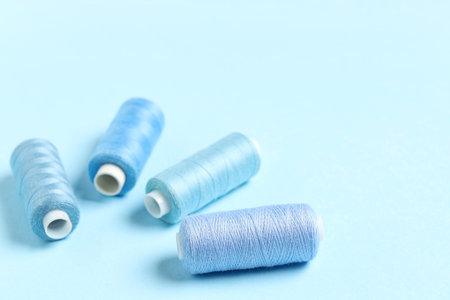 Spools of thread on blue background, closeupの写真素材