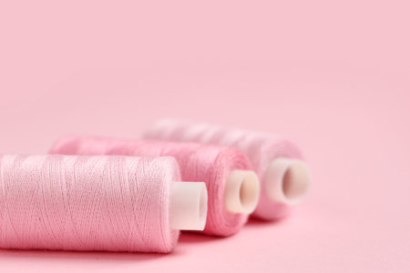 Spools of thread on pink background, closeupの写真素材