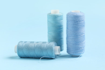 Spools of thread on blue background