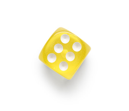 Yellow game dice on white backgroundの写真素材