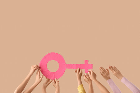 Many female hands with symbol of woman on beige background. Feminism conceptの写真素材
