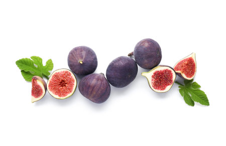 Fresh ripe figs and leaves on white background