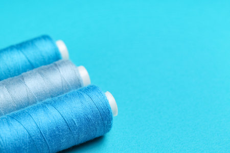 Spools of thread on blue background, closeupの写真素材