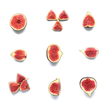 Cut fresh ripe figs on white background