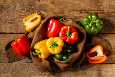 Fresh colorful bell peppers on wooden backgroundの写真素材