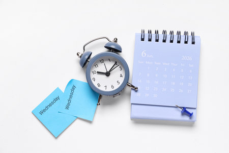 Calendar with alarm clock, sticky notes and paper pin on white backgroundの写真素材