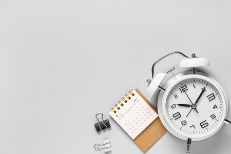 Calendar with alarm clock and binders on gray backgroundの写真素材