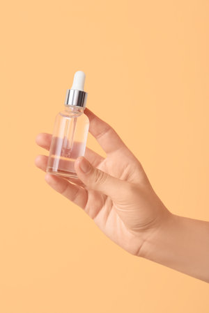 Female hand with bottle of essential oilの写真素材