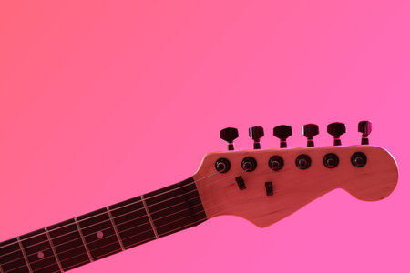 Modern electric guitar on pink background, closeupの写真素材