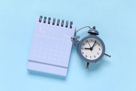Calendar with alarm clock on blue backgroundの写真素材