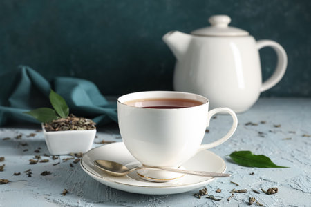 Cup of tasty black tea on blue grunge background, closeupの写真素材