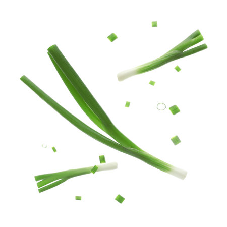 Flying fresh green onion with slices on white backgroundの写真素材