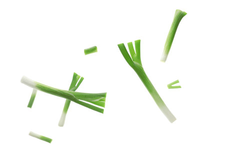 Flying pieces of green onion on white backgroundの写真素材