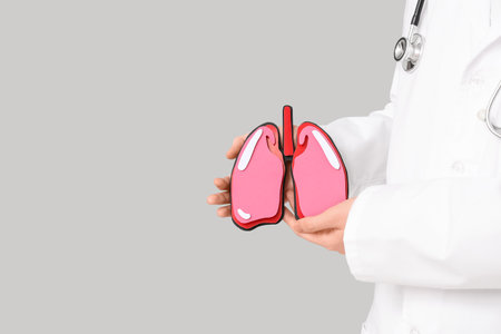 Female doctor with lungs on gray background, closeupの写真素材