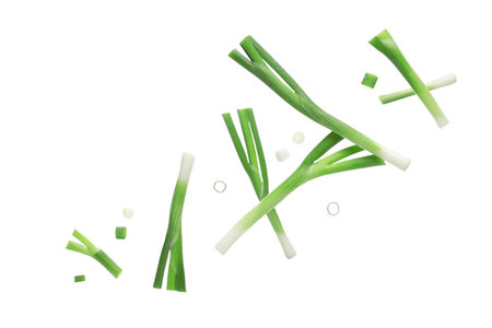 Flying pieces of green onion with slices on white backgroundの写真素材