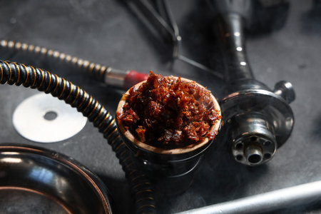 Parts of hookah and tobacco on black background