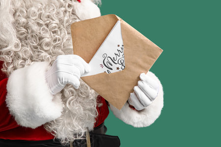 Santa Claus with letter on green background, closeupの写真素材