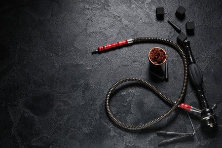 Parts of hookah with tobacco on black grunge background