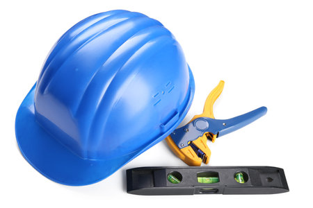 Hardhat, wire stripper and bubble level isolated on white background