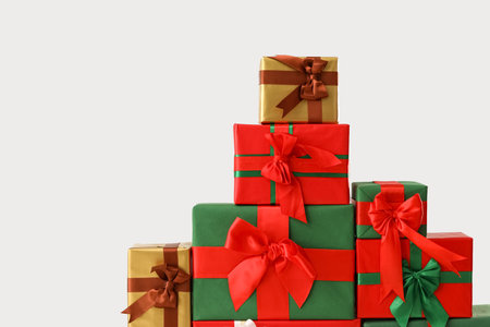 Stack of different Christmas gift boxes on white background, closeup
