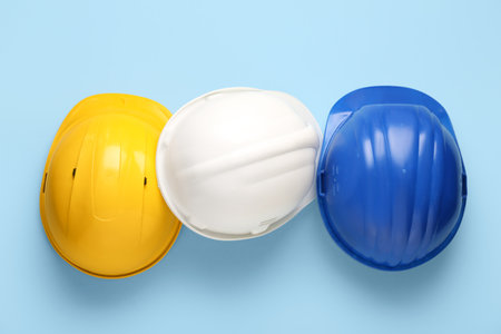 Colorful hardhats on blue backgroundの写真素材