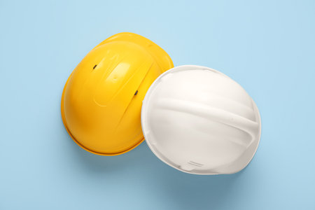 White and yellow hardhats on blue backgroundの写真素材