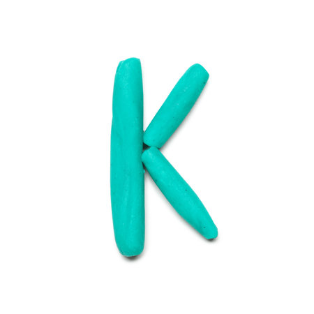 Letter K made of plasticine on white backgroundの写真素材