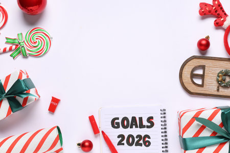 Notebook with new goals for 2026 year, Christmas gifts and decor on white background