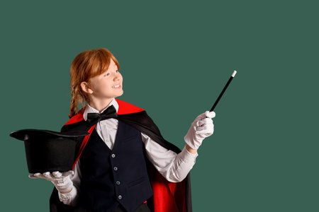 Young magician showing magic trick on green backgroundの写真素材