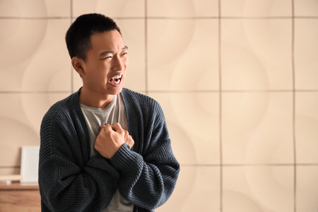 Young Asian man at homeの写真素材