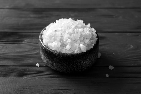 Bowl of sea salt on dark wooden backgroundの写真素材
