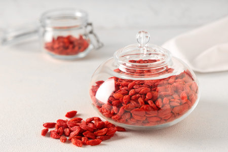 Jar with dried goji berries on white background, closeupの写真素材
