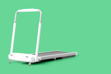 White treadmill on green backgroundの写真素材