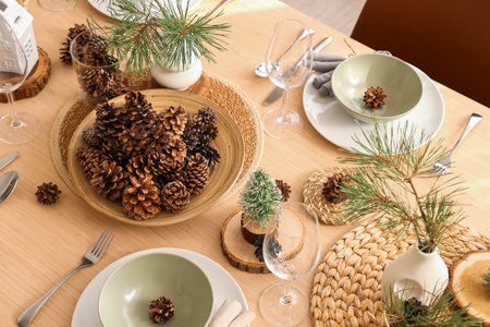 Winter table setting with pine cones and branches in room, top viewの写真素材