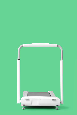 White treadmill on green backgroundの写真素材