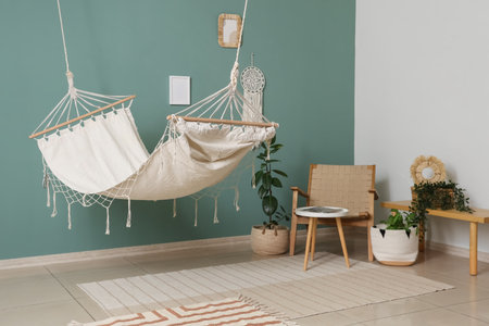 Interior of room with hammock, armchair and plantsの写真素材