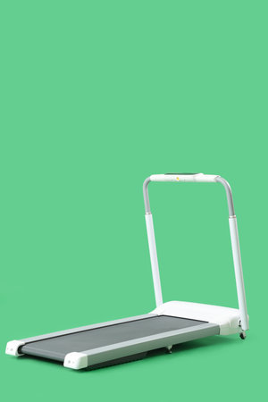 White treadmill on green backgroundの写真素材