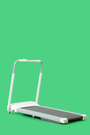 White treadmill on green backgroundの写真素材