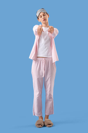 Female in pajamas on blue backgroundの写真素材